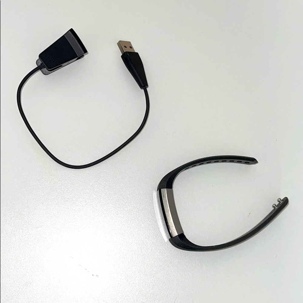 Black Fitbit with charger.